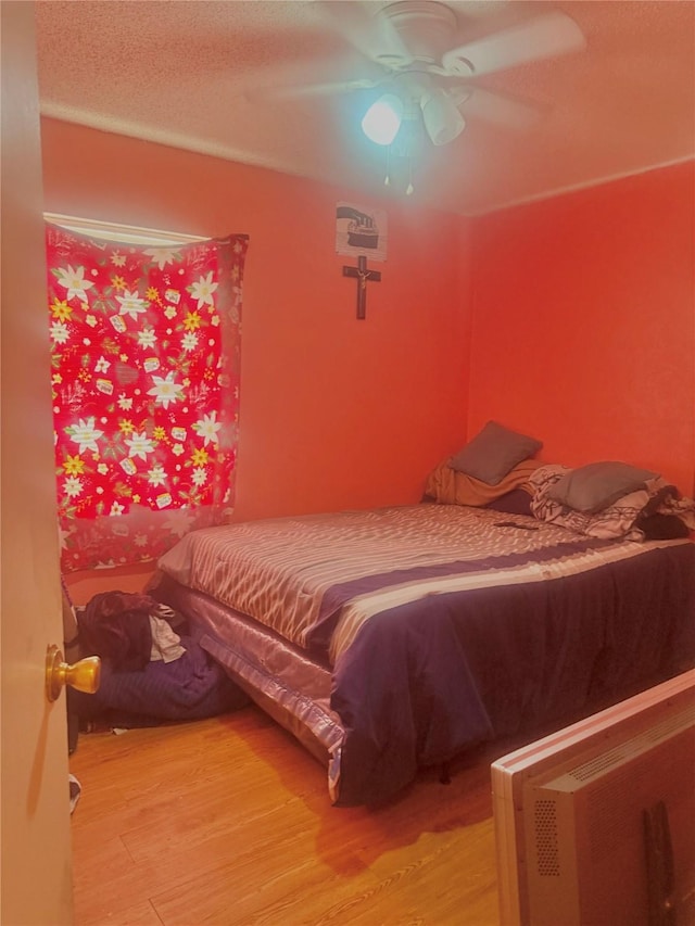 bedroom featuring hardwood / wood-style flooring and ceiling fan