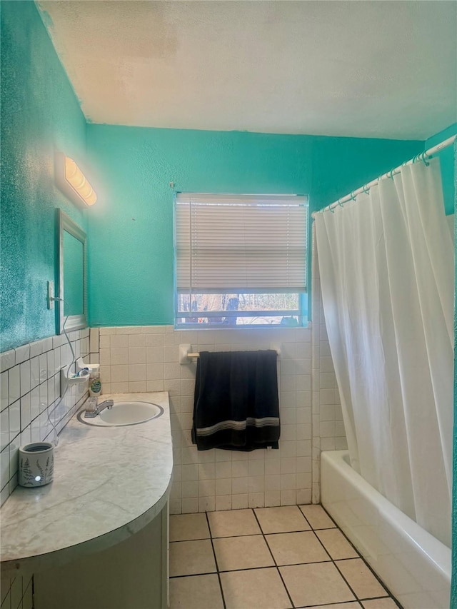 bathroom featuring tile walls, shower / bath combo, vanity, and tile patterned flooring