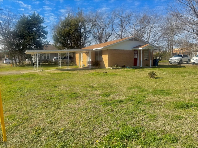 single story home with a front yard and a carport