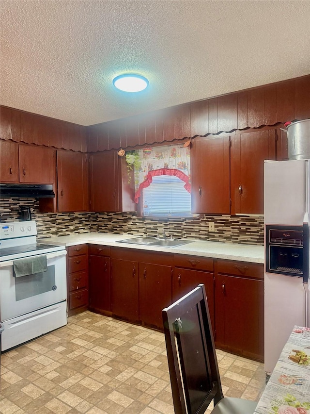 kitchen with sink, white appliances, a textured ceiling, and decorative backsplash