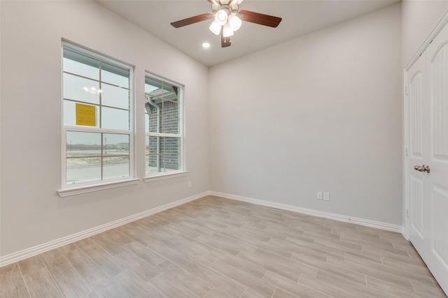 empty room featuring a ceiling fan, recessed lighting, light wood-style flooring, and baseboards