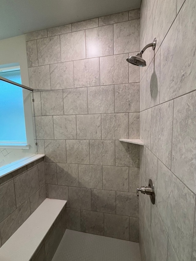 bathroom with a tile shower