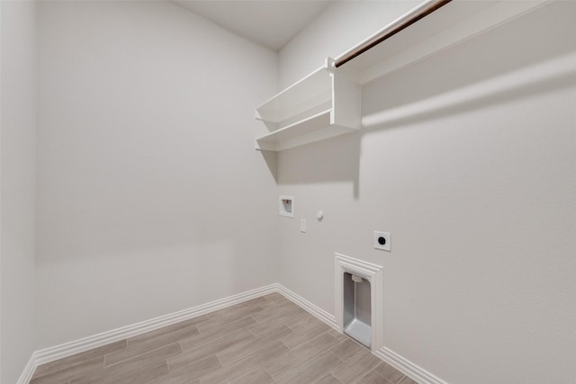 laundry area with washer hookup, wood tiled floor, hookup for an electric dryer, gas dryer hookup, and laundry area