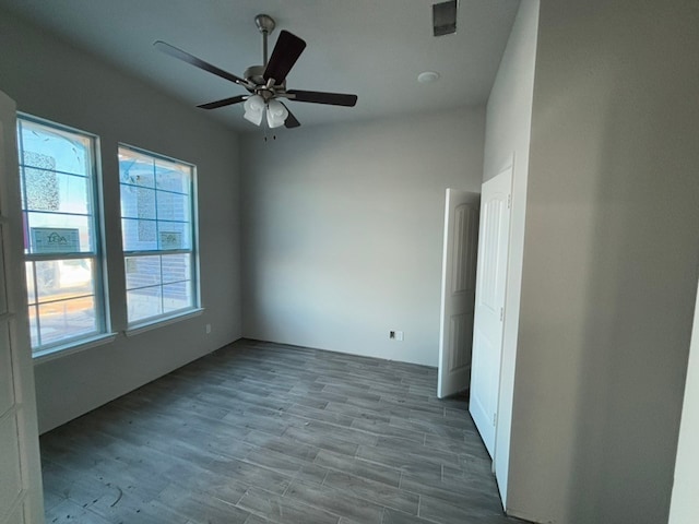 empty room featuring ceiling fan and wood-type flooring