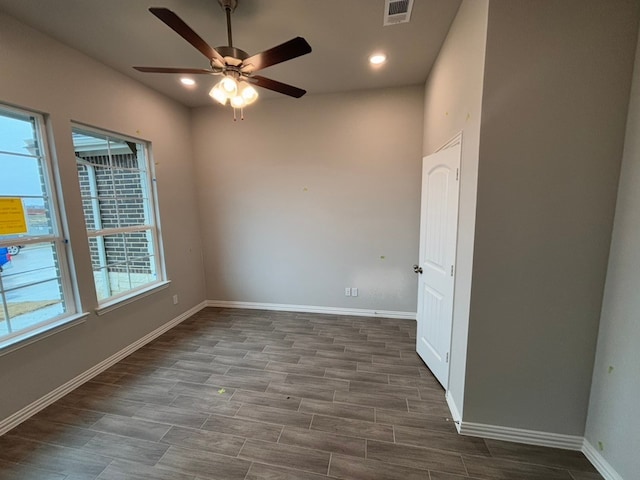 empty room with dark wood-type flooring and ceiling fan