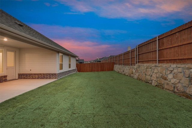 view of yard with a patio area and a fenced backyard