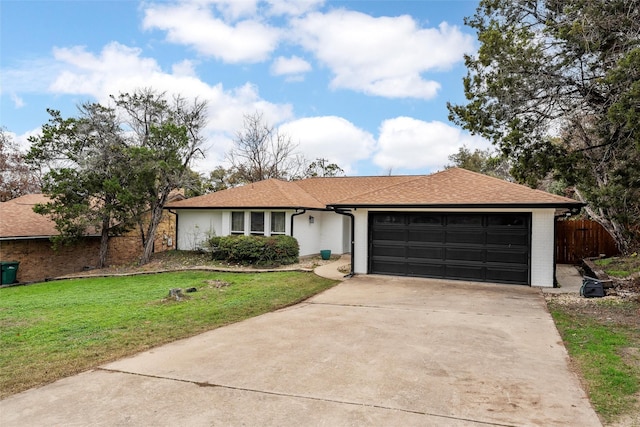 ranch-style home featuring a garage and a front lawn