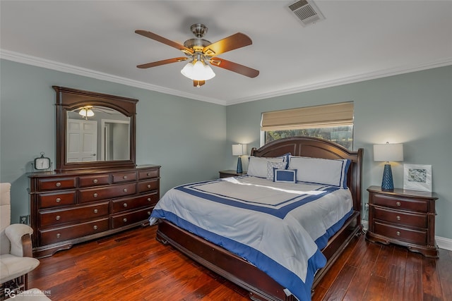 bedroom featuring dark hardwood / wood-style flooring, ceiling fan, and crown molding