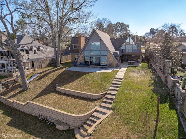 back of property with a yard and a patio area