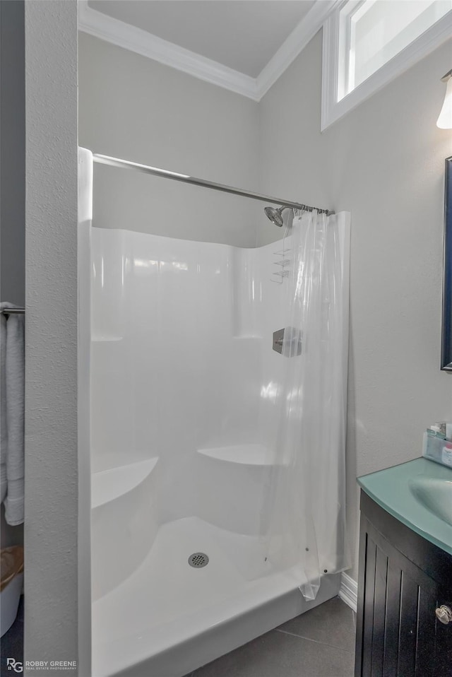 bathroom with tile patterned floors, a shower with curtain, ornamental molding, and vanity