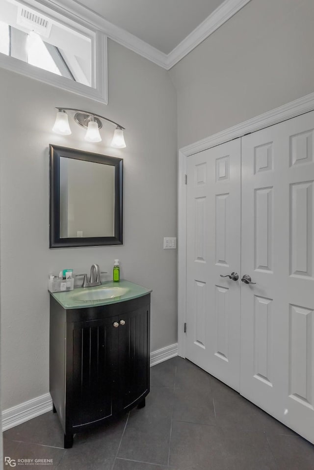 bathroom with tile patterned flooring, vanity, and crown molding