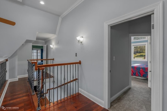 hall featuring ornamental molding, vaulted ceiling, and a healthy amount of sunlight