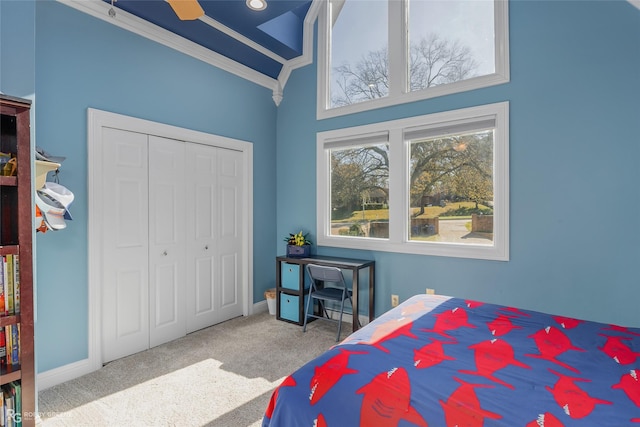 bedroom featuring light carpet, high vaulted ceiling, a closet, and ornamental molding