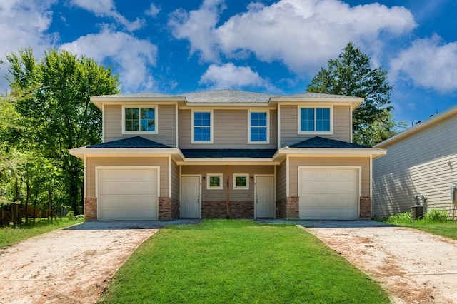 view of front of property featuring a garage and a front lawn