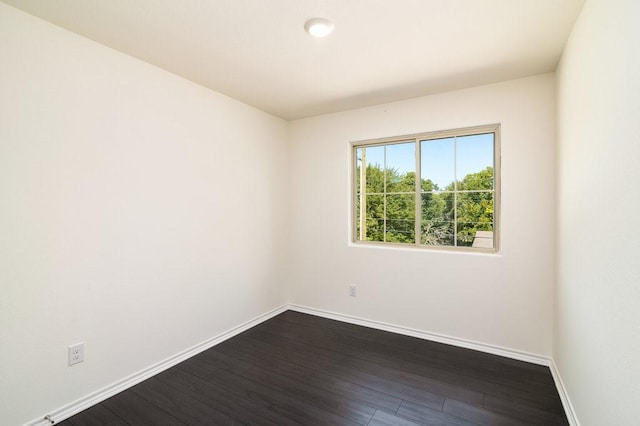 spare room with dark wood-type flooring