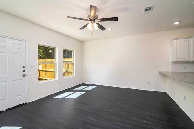 unfurnished room featuring ceiling fan and dark hardwood / wood-style flooring