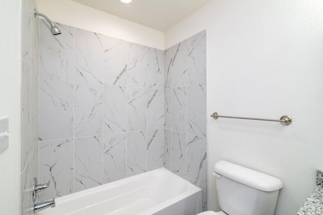 bathroom with toilet and tiled shower / bath combo