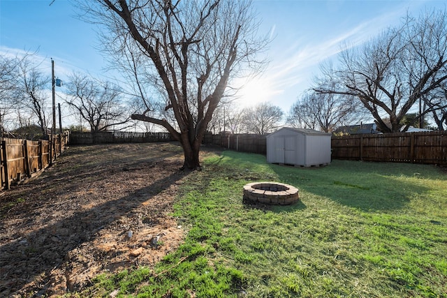 view of yard with a fire pit and a storage shed