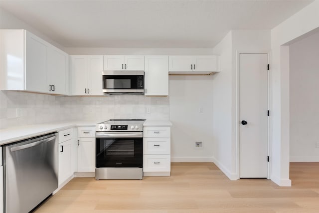 kitchen with backsplash, light hardwood / wood-style flooring, white cabinets, and stainless steel appliances