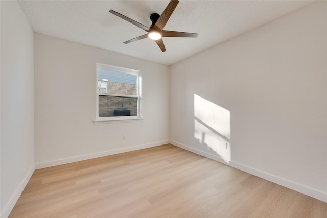 spare room with ceiling fan and light hardwood / wood-style flooring