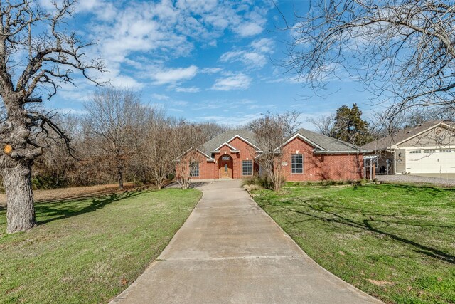 ranch-style home with a front yard and a garage