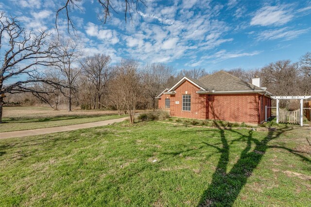 view of side of property with a yard