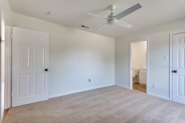 unfurnished bedroom featuring light carpet, ensuite bath, and ceiling fan