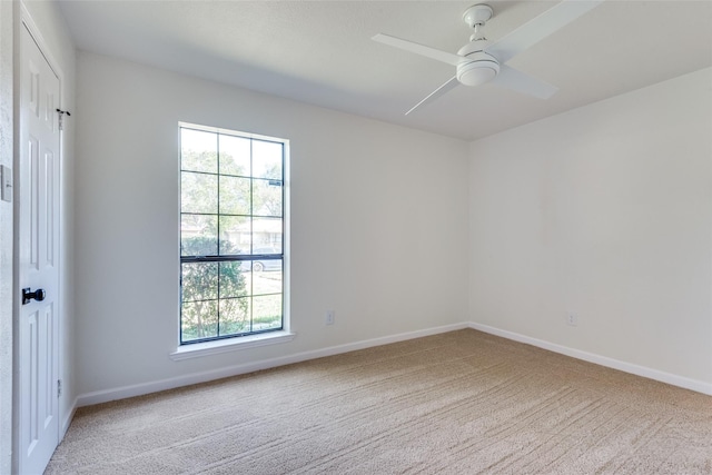 carpeted empty room with ceiling fan