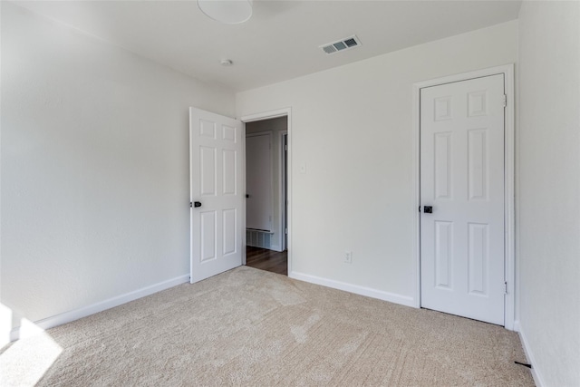 unfurnished bedroom with light colored carpet