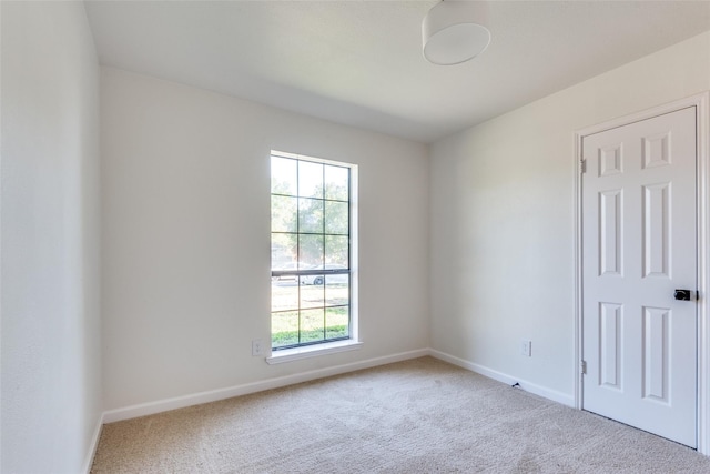 carpeted empty room with a healthy amount of sunlight