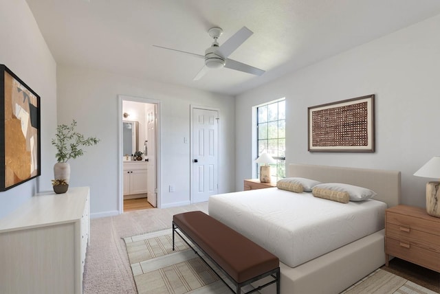 carpeted bedroom featuring ensuite bath, ceiling fan, and a closet