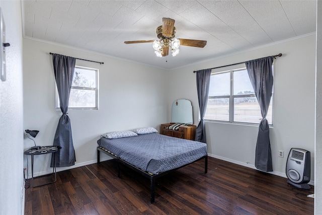 bedroom with ornamental molding, baseboards, a ceiling fan, and wood finished floors