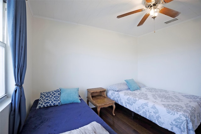 bedroom with ceiling fan, ornamental molding, and hardwood / wood-style floors