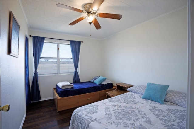bedroom featuring baseboards, a ceiling fan, ornamental molding, and wood finished floors