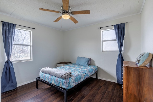 bedroom with dark hardwood / wood-style flooring, multiple windows, and ornamental molding