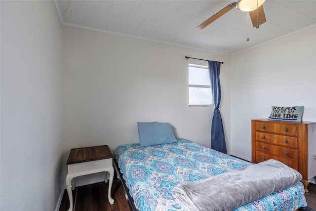 bedroom with a ceiling fan, wood finished floors, baseboards, and ornamental molding