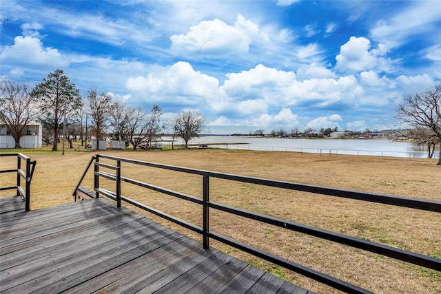 wooden deck featuring a water view and a yard