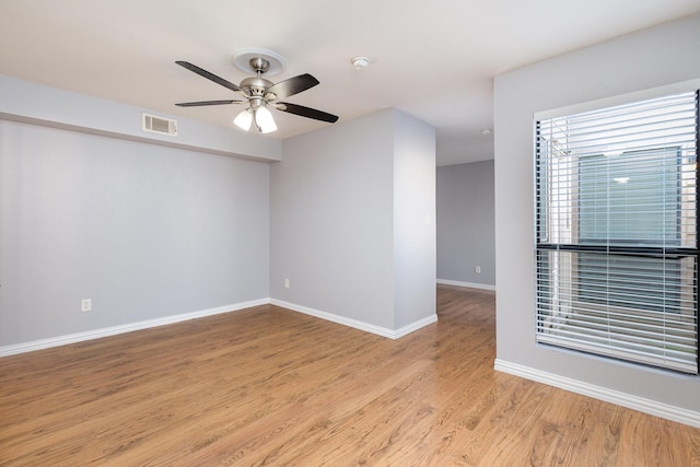 unfurnished room with light wood-type flooring and ceiling fan