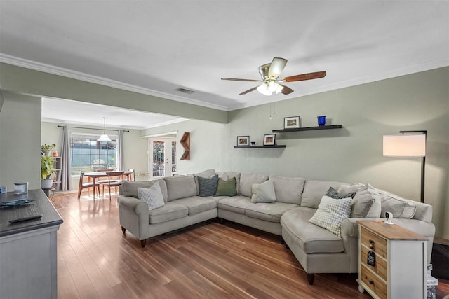 living room with french doors, dark wood-type flooring, ceiling fan, and ornamental molding