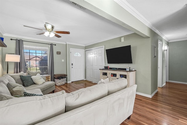 living room with crown molding, dark hardwood / wood-style flooring, and ceiling fan