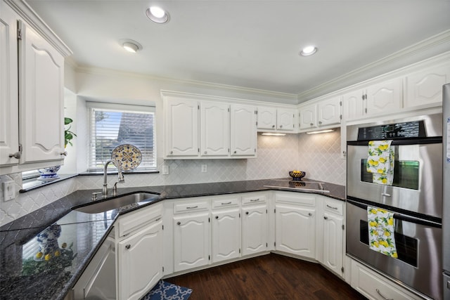 kitchen with white cabinetry, stainless steel appliances, dark wood-type flooring, and sink