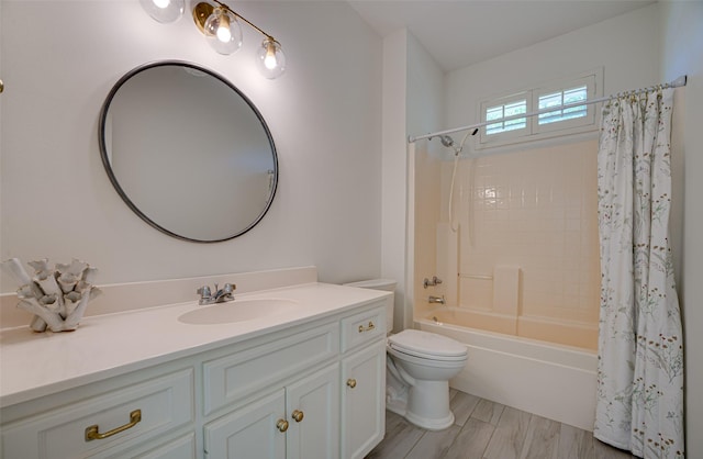 full bathroom featuring shower / bath combo, vanity, and toilet