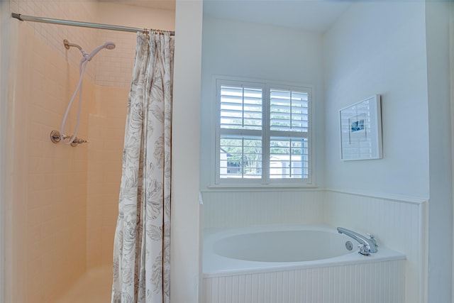 bathroom featuring independent shower and bath