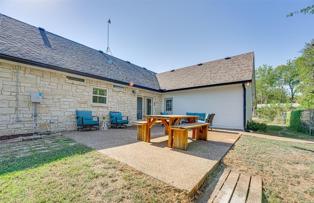 rear view of property with a yard and a patio