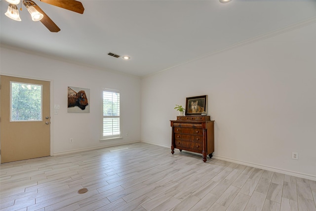 spare room with light hardwood / wood-style floors, ceiling fan, and crown molding