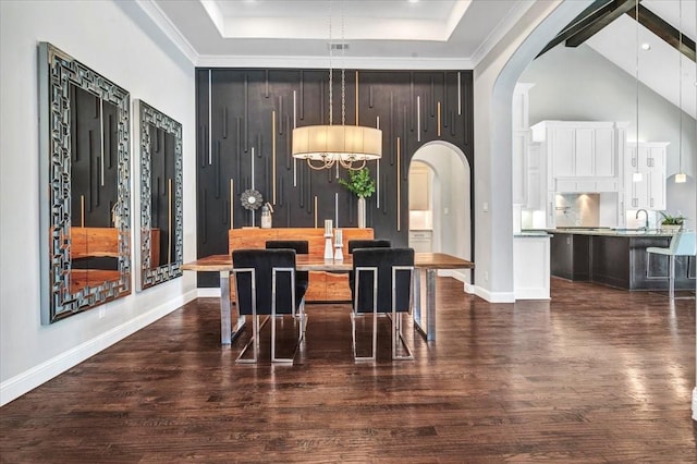 dining room with a chandelier, a high ceiling, and dark hardwood / wood-style floors