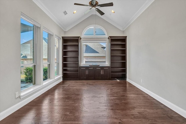 empty room featuring ceiling fan, dark wood-type flooring, vaulted ceiling, and ornamental molding