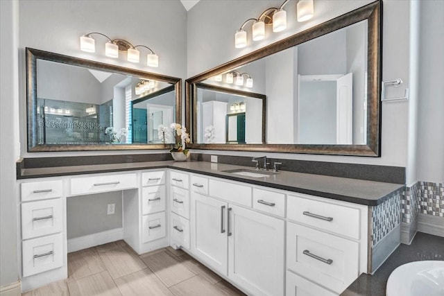 bathroom with vanity and lofted ceiling