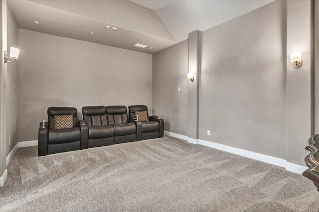 carpeted home theater featuring lofted ceiling