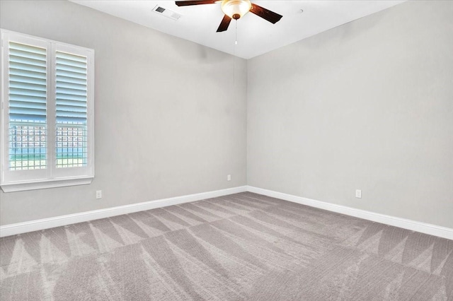 carpeted empty room featuring ceiling fan